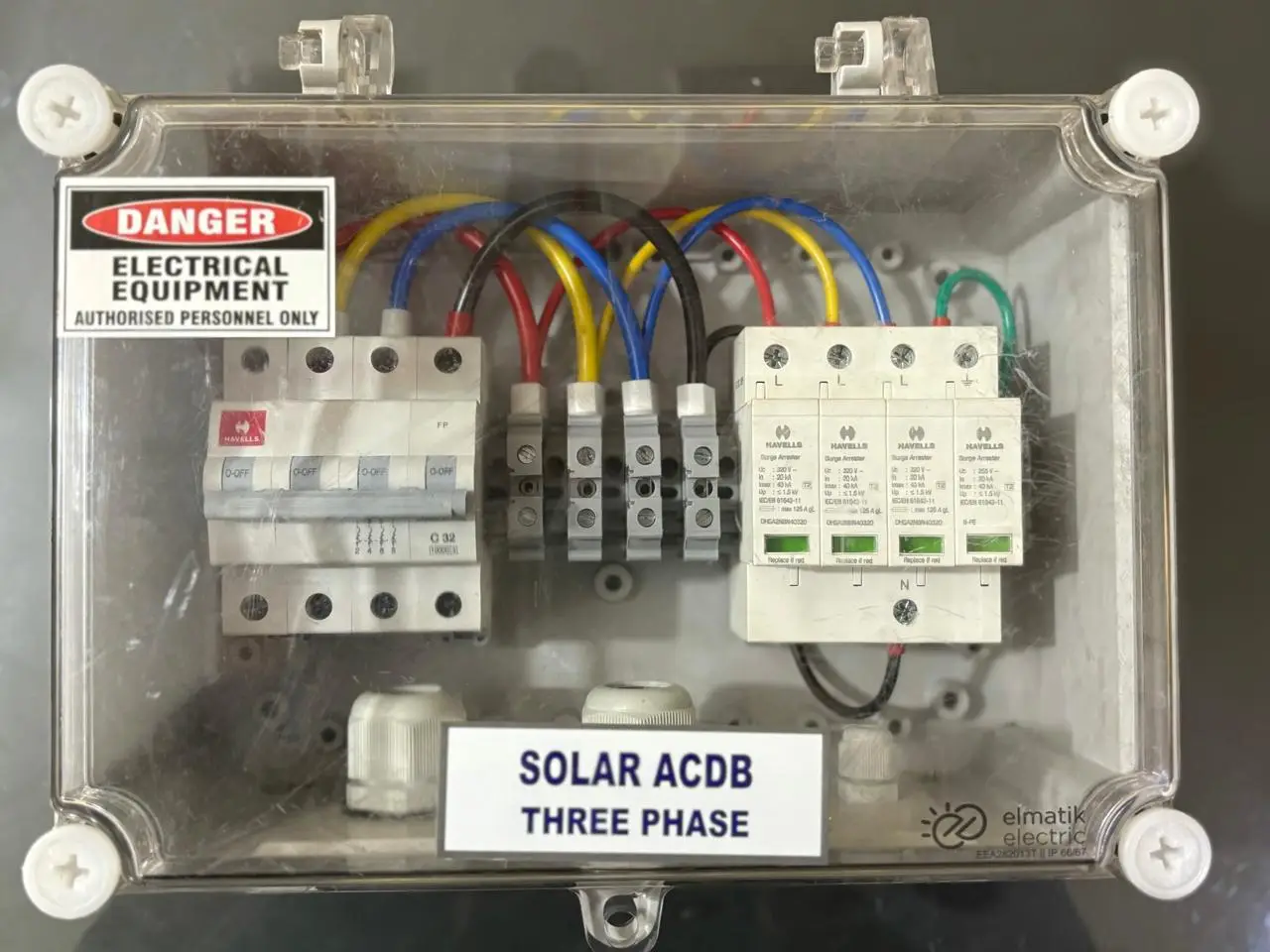 Three-phase solar ACDB with a Havells four-pole MCB and surge arresters in a transparent enclosure